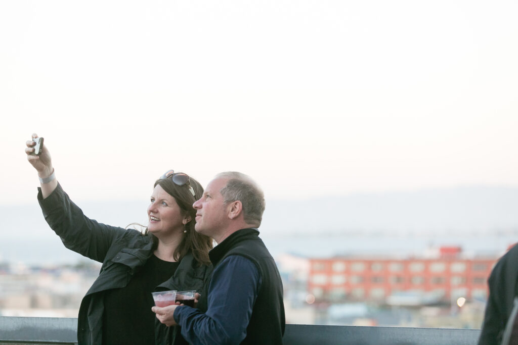 A couple take a selfie on a balcony