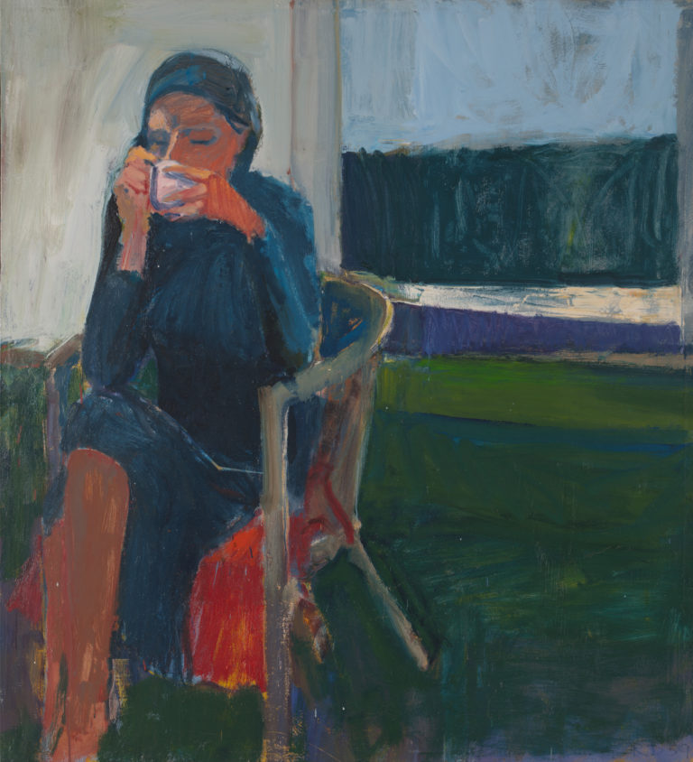 Seated woman drinking from a cup