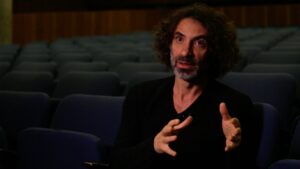Artist Rabih Mroué in an empty movie theater