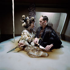 Matthew Barney, film still of man and woman facing each other holding knives