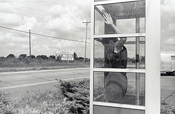 Wessel, woman in telephone booth on side of road in Oklahoma