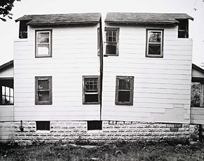 side view of white paneled building split in half