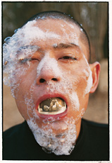 Color photograph of an Asian man smoking, Huan