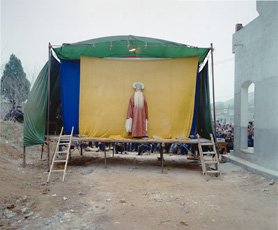 A color photograph of a makeshift stage, Luo Dan