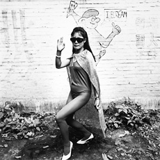 A black and white photograph of an Asian woman wearing sunglasses and a body suit, Liu Zheng