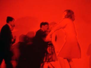 Anne Colvin, video still, red image of four people dancing
