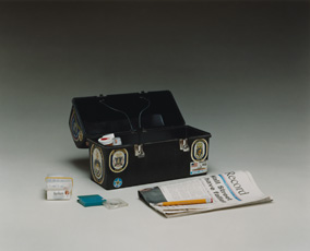 Gary Gilpatrick, box with newspaper and pencil