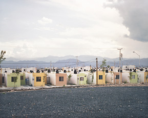 photo of patterend green yellow and brown cubic houses lined up on street