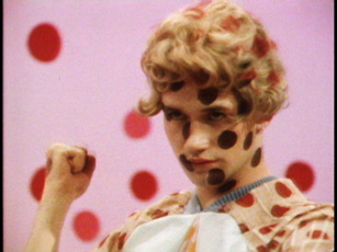 Charles Atlas, video still woman making fist covered in red dots