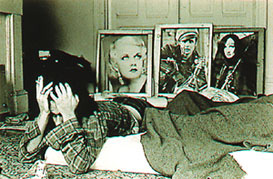 William Gedney, man on bed with three framed photos in back
