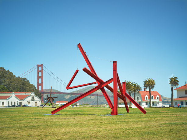 Mark di Suvero, red metal sculpture on field in front of golden gate bridge