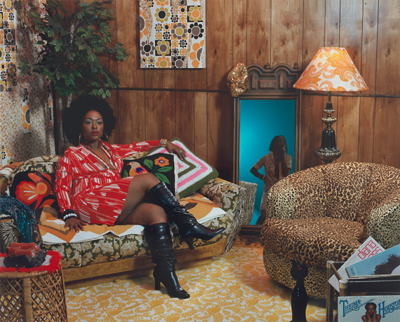 Mickalene Thomas, woman in red dress sitting on couch in colorful living room