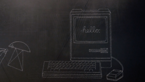 A chalkboard drawing of a vintage Mac computer with the word "hello." written on the screen.