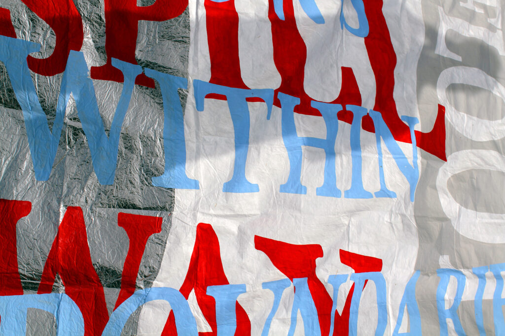 A banner with blue, red and white overlapping words