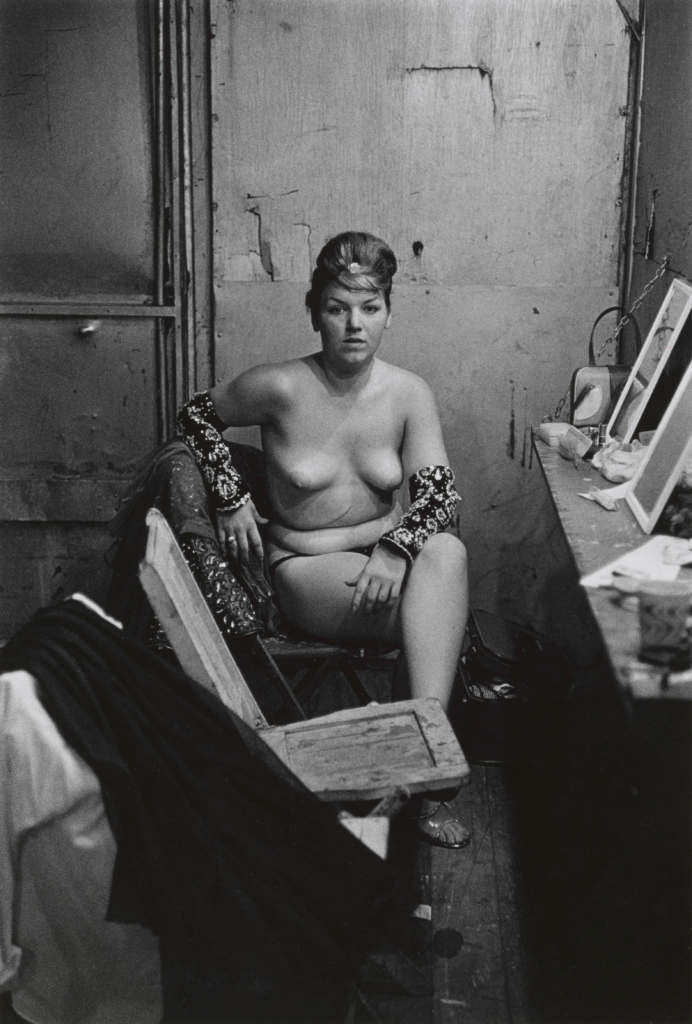 Artwork image, Diane Arbus, Stripper with bare breasts sitting in her dressing room
