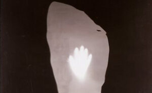 A black and white photogram with a hand