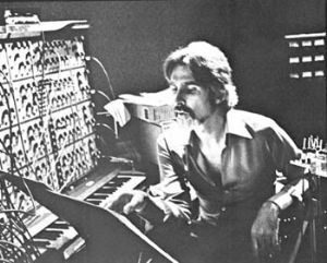 Black and white photo of a Caucasian man in a recording studio