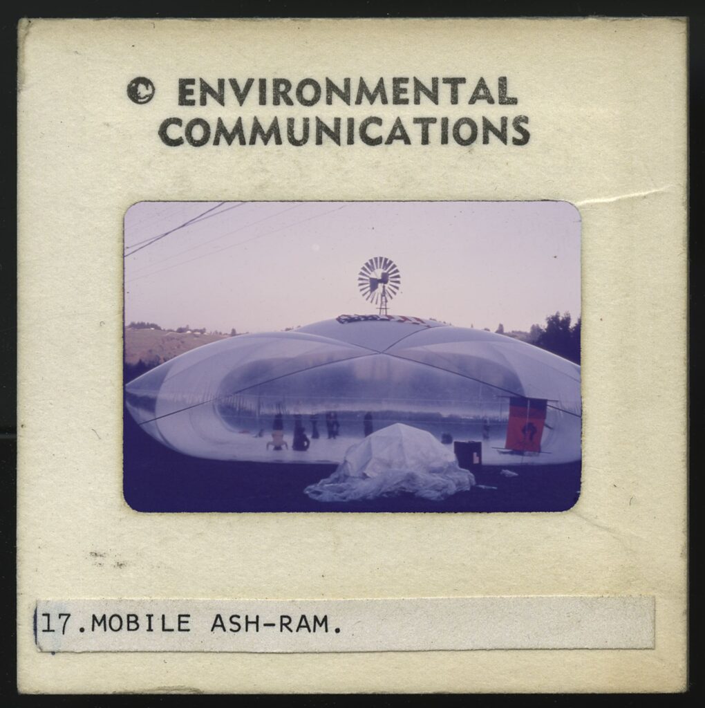 Slide with people inside an inflatable structure labeled Mobile Ash-ram