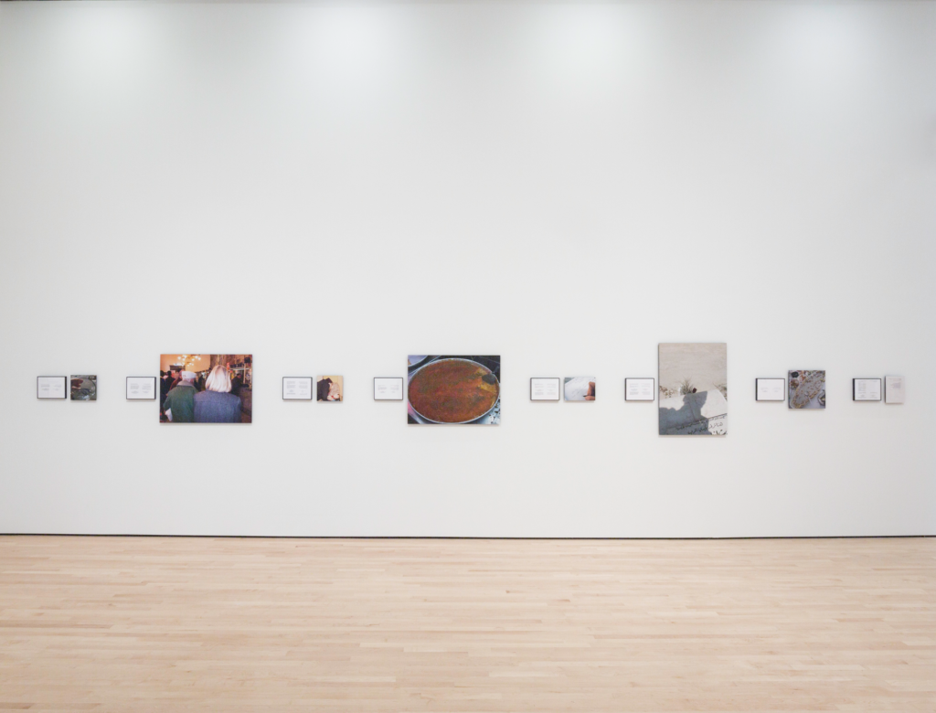 A white gallery space featuring photographs and writing