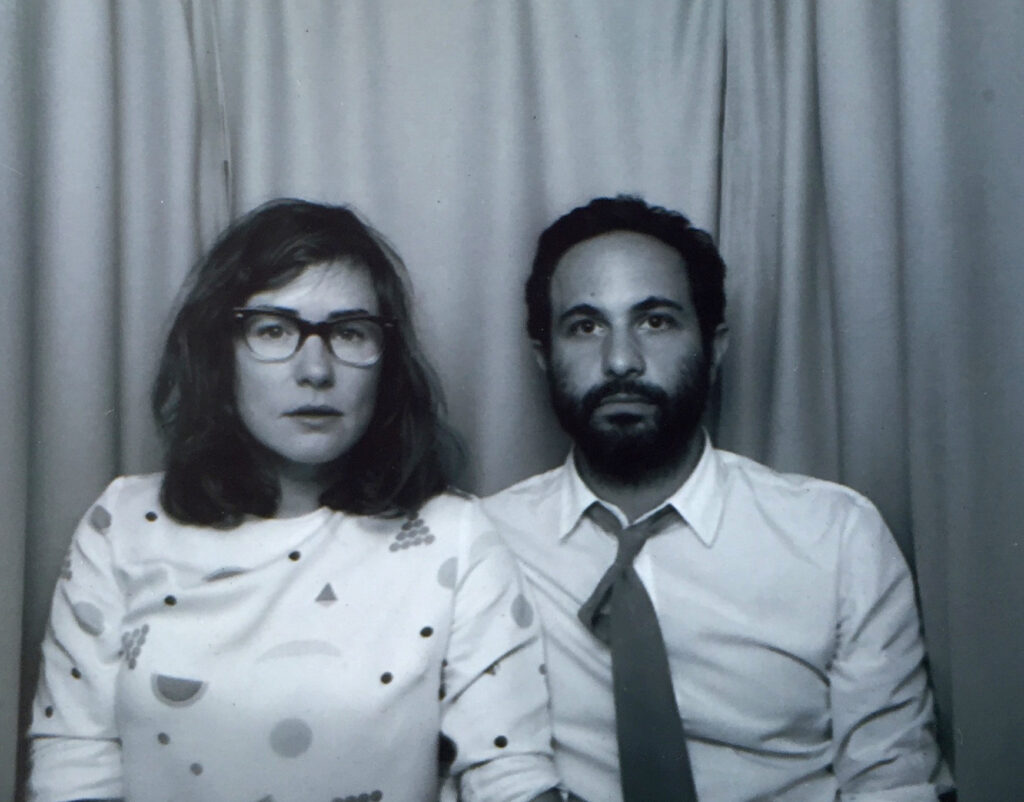 A photobooth image of a seated woman and man