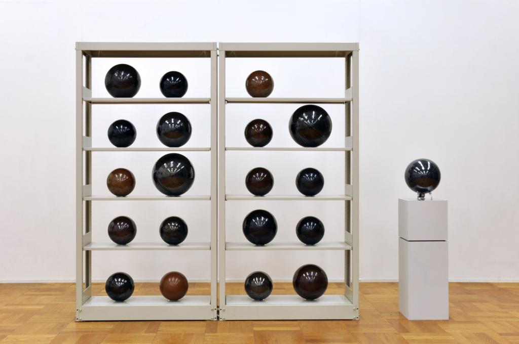 Several spheres on a shelf create a grid, Yagi Soundtracks
