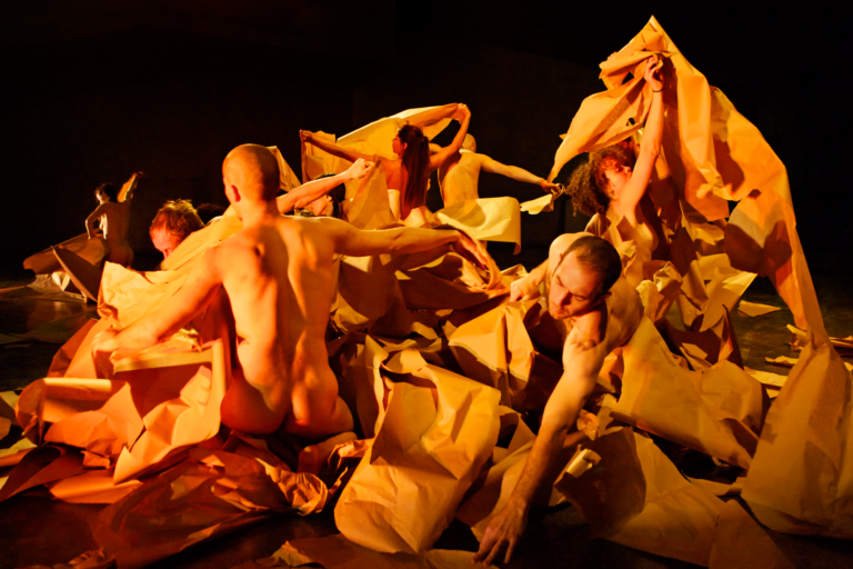 Nude figures move through torn pieces of paper bags, Anna Halpern Soundtracks