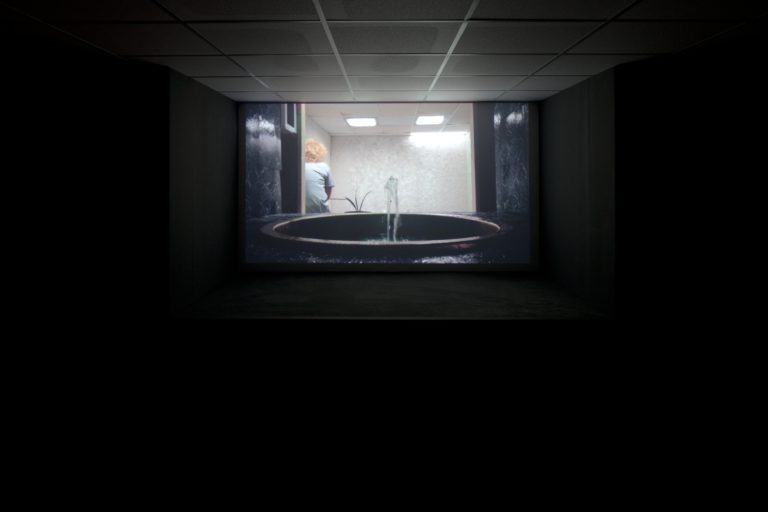 A projection of a fountain with a person in the background