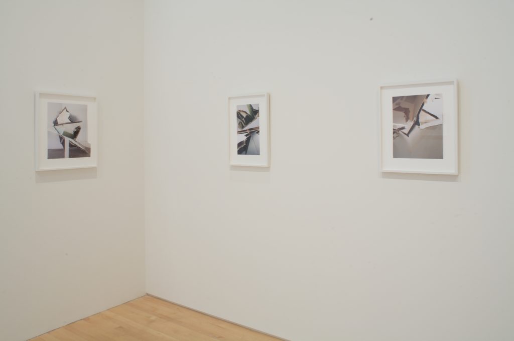 Several framed photographs of drywall sculptures