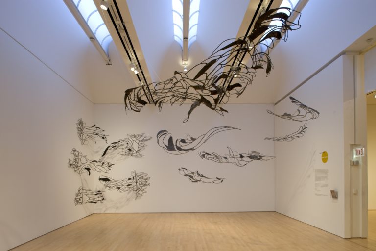 A room filled with hanging metallic sculptures