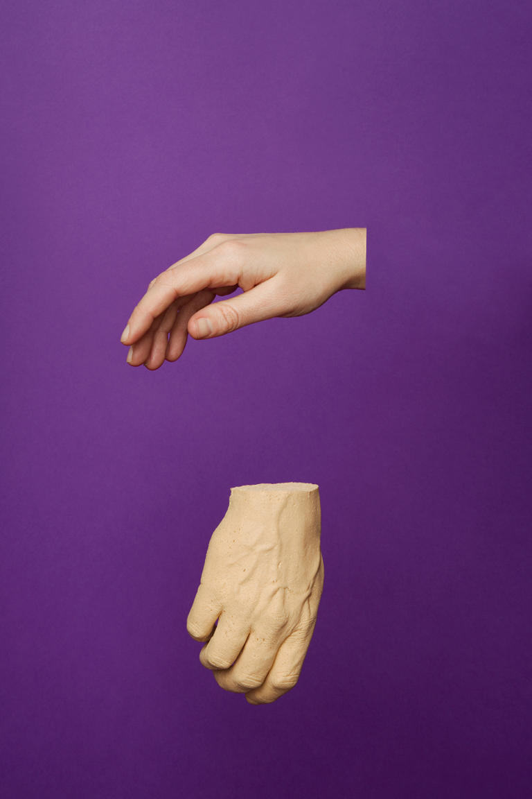 Two disembodied hands suspended against a purple background