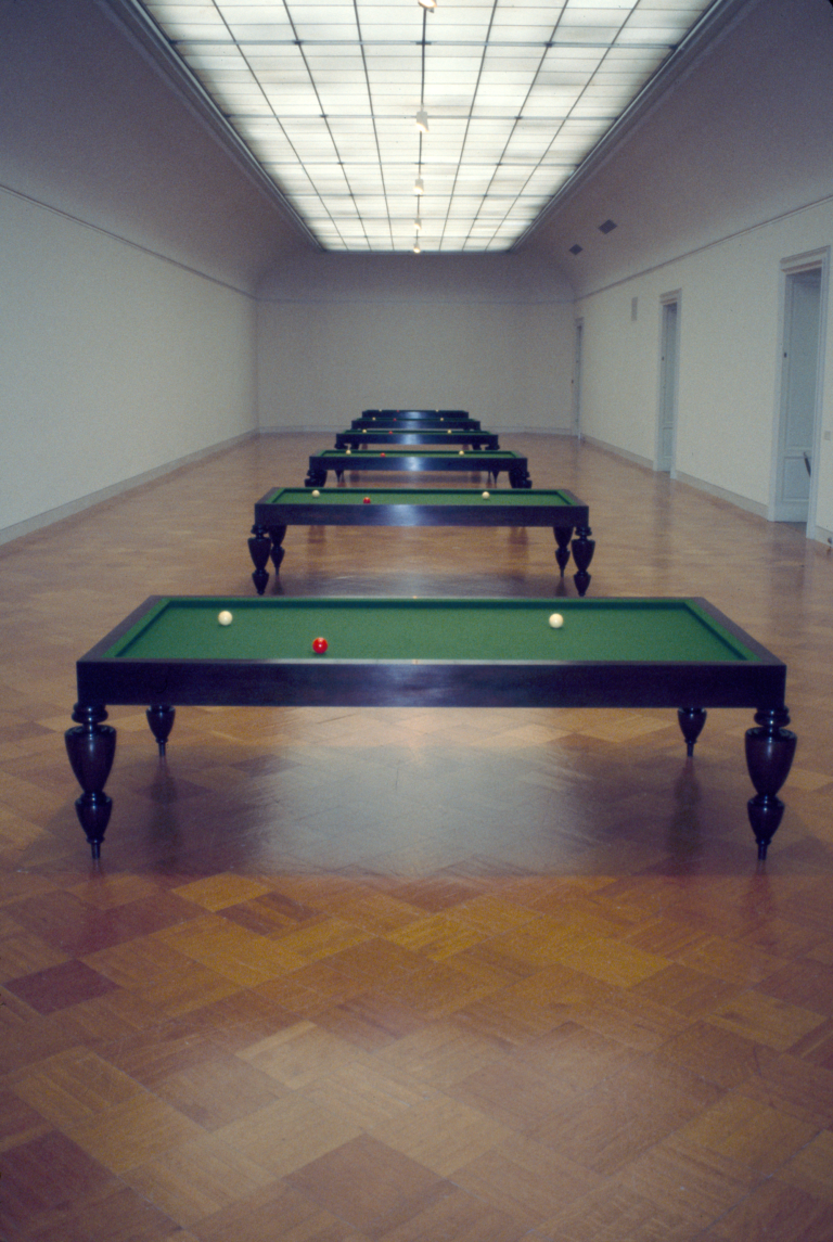 Five billiards tables standing in a row with two white balls and one red ball placed in the same position on each