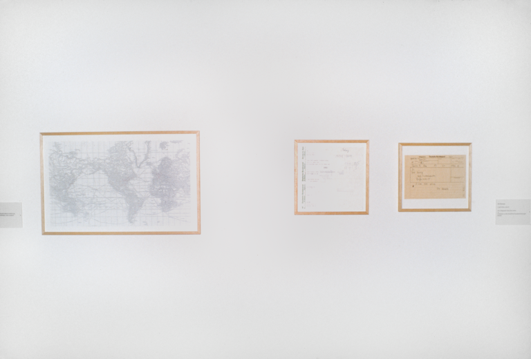 A map and other documents framed and hung on a wall