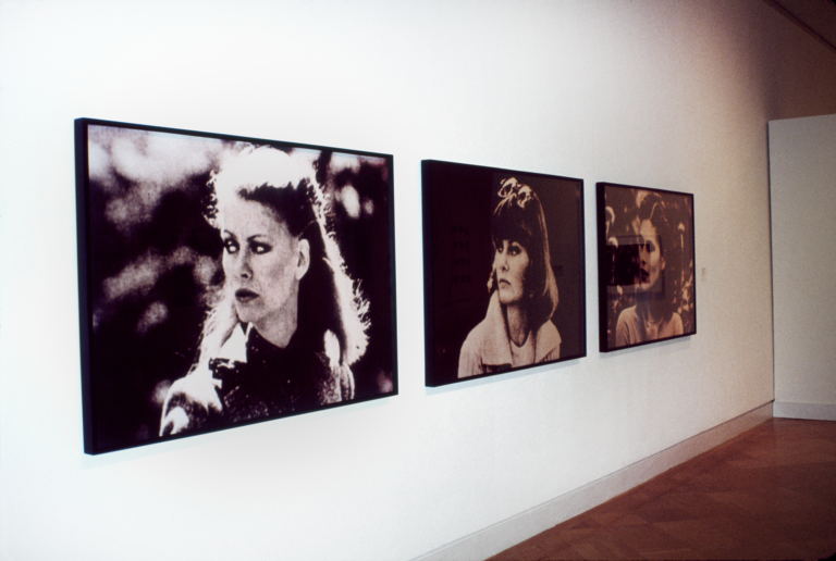 Three photographic portraits of women hung on a gallery wall