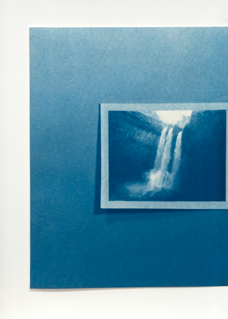 A Cyanotype of a photograph of three waterfalls hung on a wall