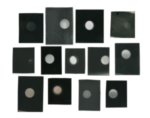 A series of gelatin silver prints with a black background and a white orb in the center