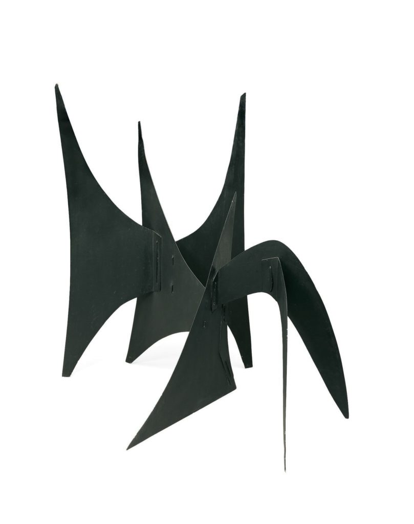 A black metal sculpture of intersecting, curvilinear planes