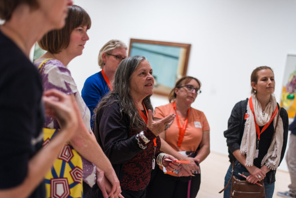Teachers discussing art in a gallery