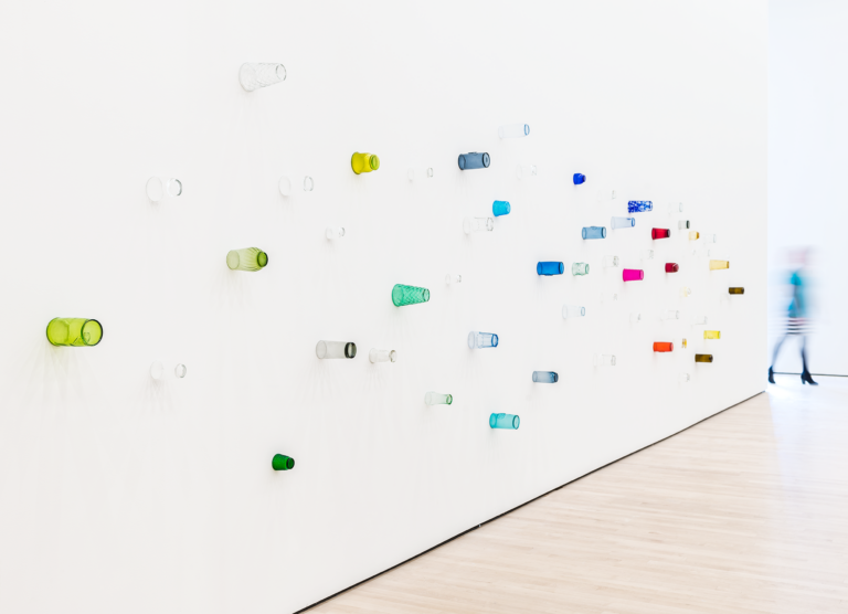 Colored drinking glasses mounted on a white wall, Pica, Soundtracks