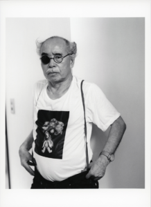 Black and white portrait of an Asian man wearing an eye patch, Araki