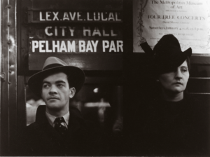 A black and white photograph showing a Caucasian man and woman in a 1940s subway car, Walker Evans