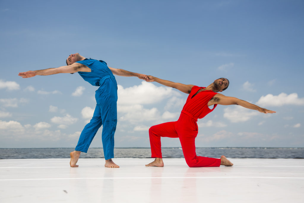 Two dancers onstage, part of Rashaun Mitchell and Silas Riener’s DESIRE LINES: RETROFIT