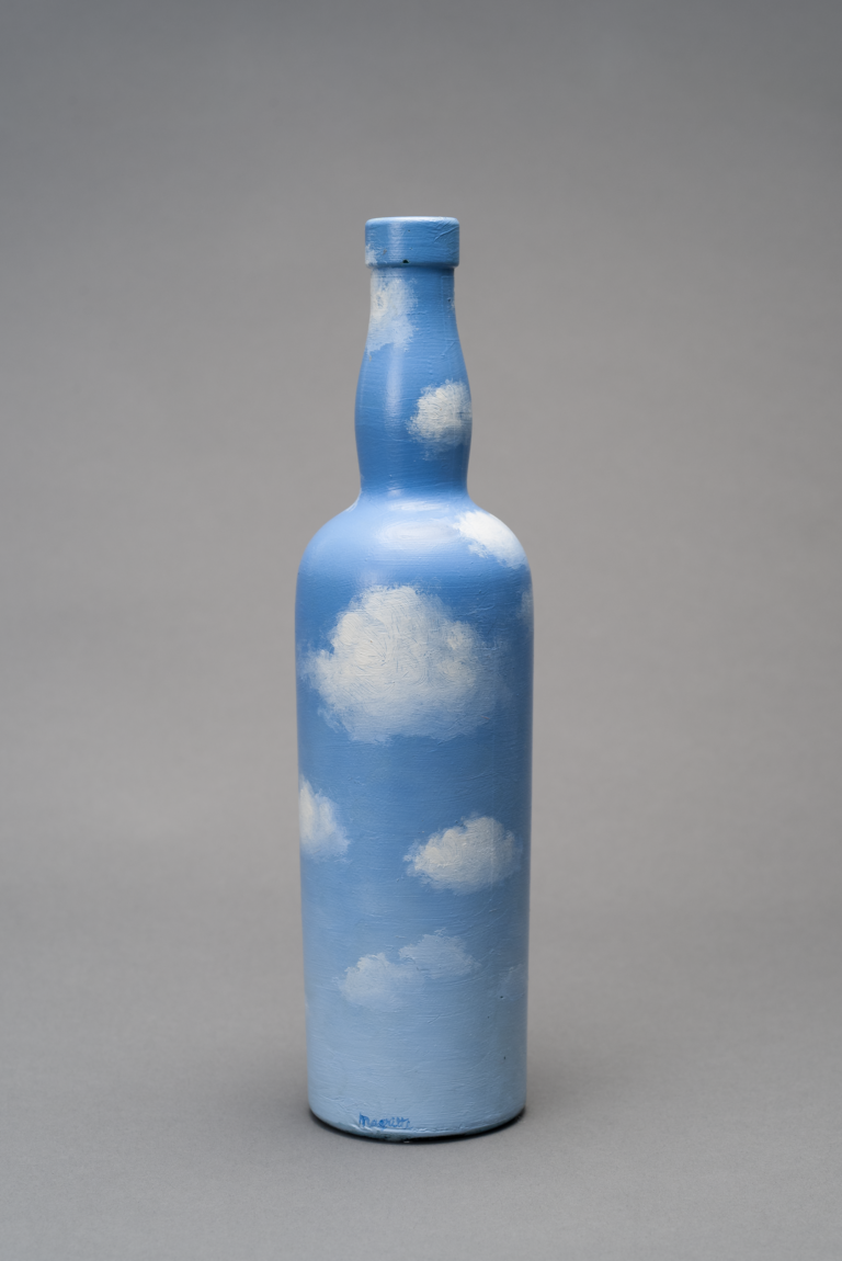 A wine bottle painted light a blue sky filled with fluffy white clouds