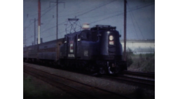A film still of an approaching train