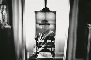 An abstracted black and white photograph of the mirror reflection of an elderly Caucasian man wearing a bowler hat, Duane Michals 