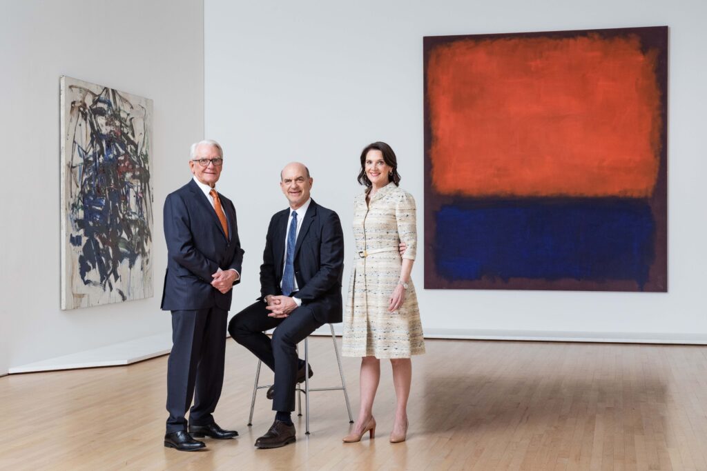 A group portrait of Charles Schwab, Robert Fisher and Diana Nelson in a gallery