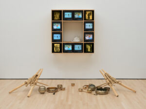 an installation with a cube of tvs mounted on a wall 