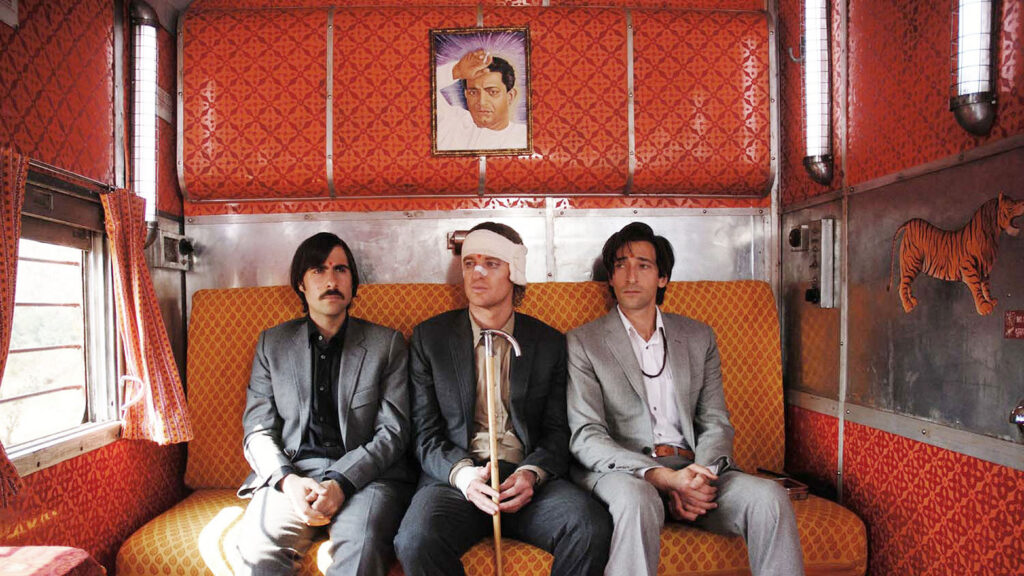 Three men sitting in a train carriage