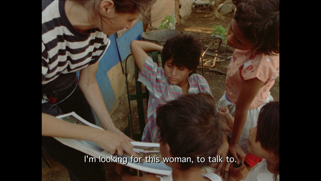 Susan Meiselas showing children photographs in search for a woman