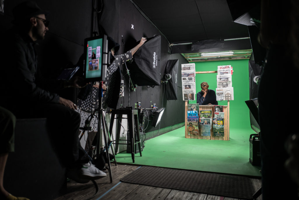 a propped up newstand in a green screen studio