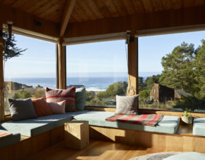 A color photograph of an interior with views of The Sea Ranch landscape